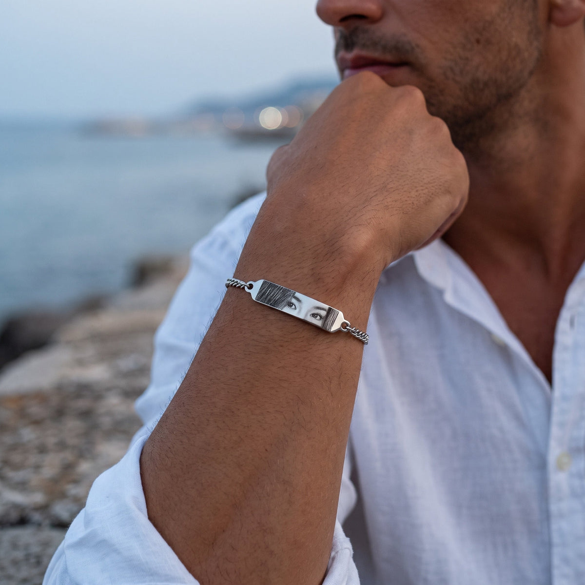 Hombre con la pulsera de ojos plateada con grabado de foto